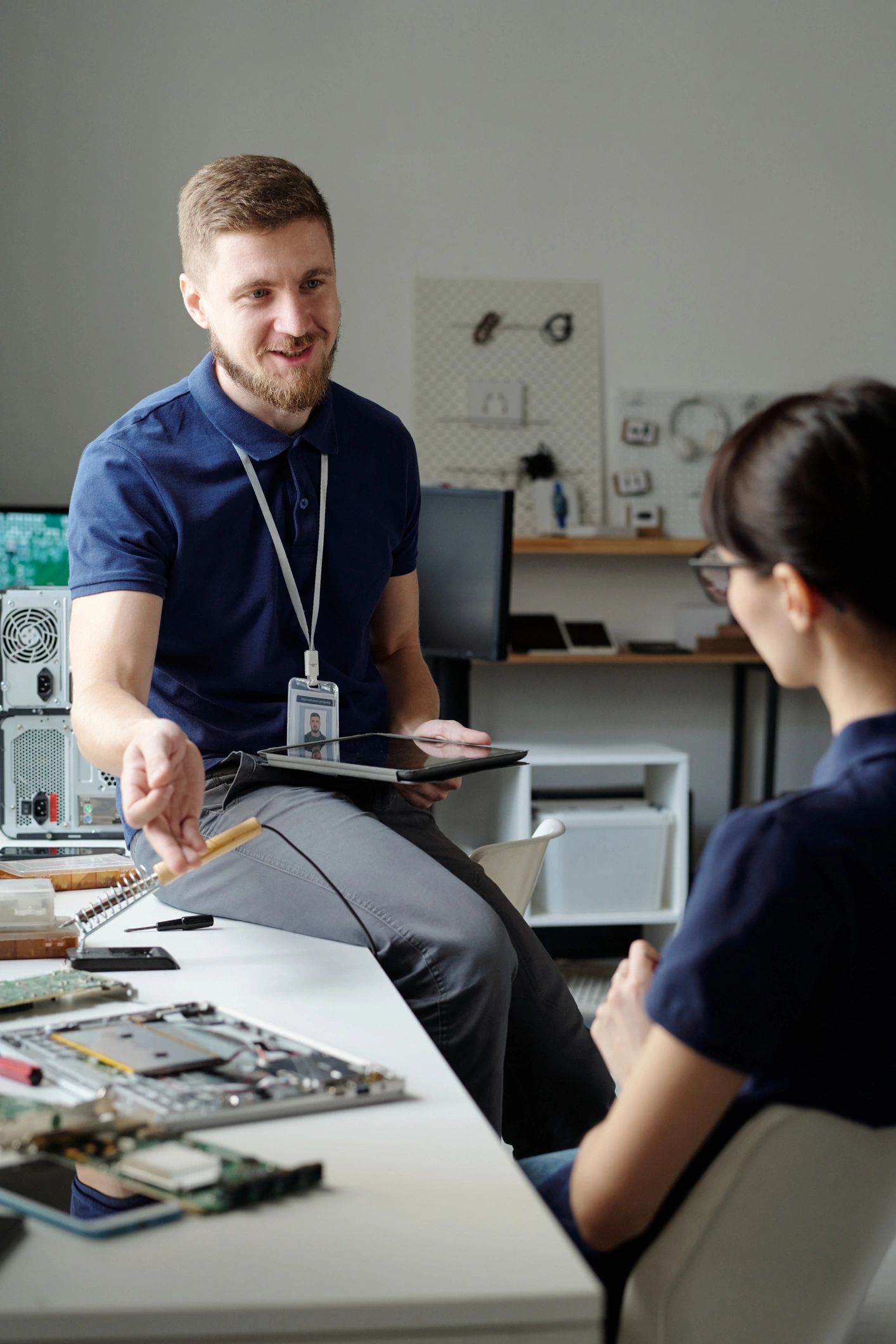 modern computer repair technician helping client
