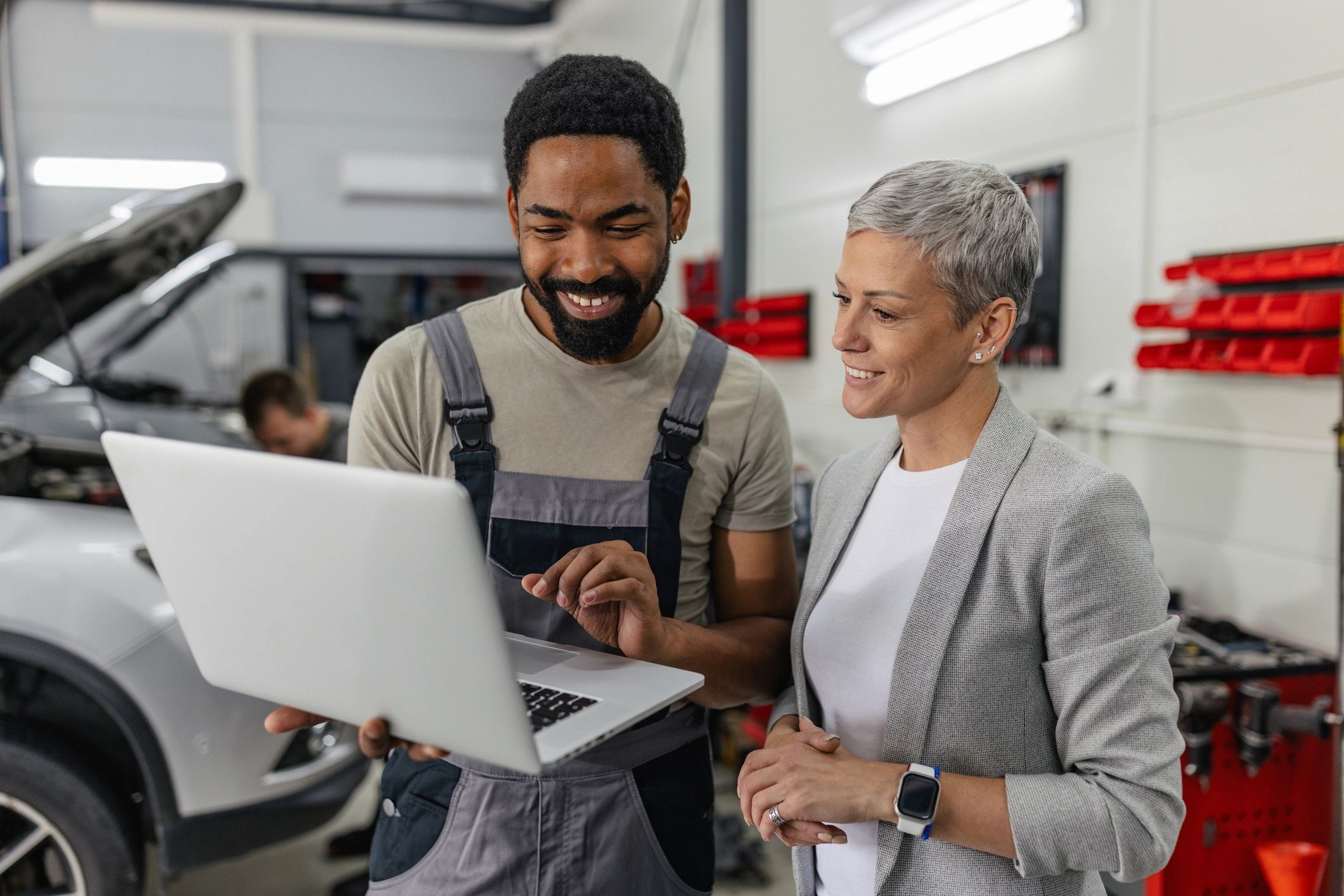 modern computer repair technician helping client